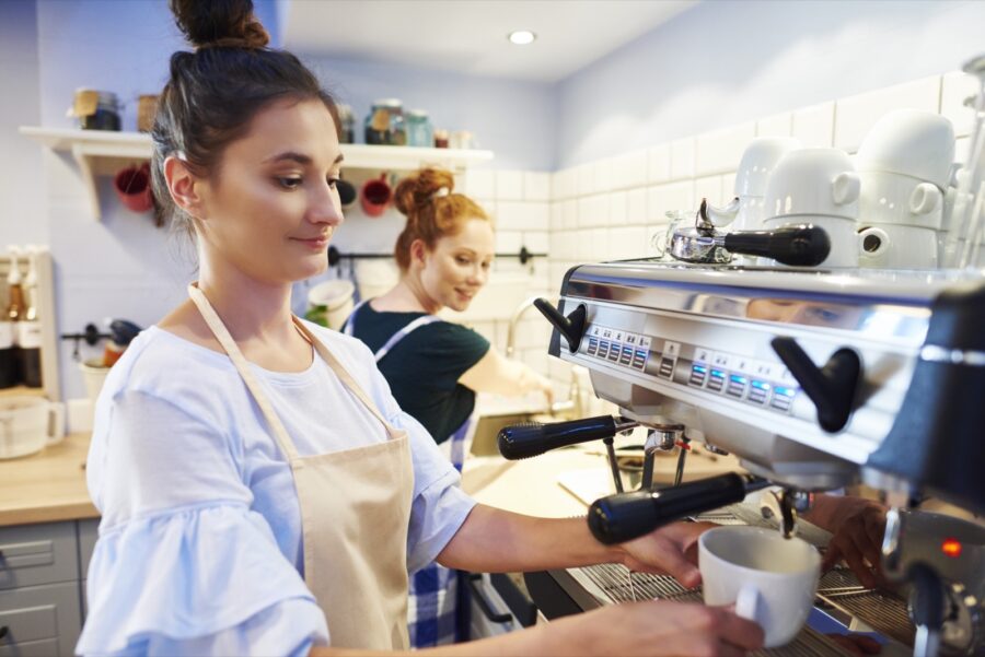 Female barista making coffee at a cafe